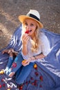 Woman at picnic eating strawberry