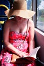 Woman in hat reading book on train bus Royalty Free Stock Photo