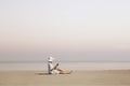 woman with hat reads a book on the beach Royalty Free Stock Photo