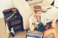 Woman, hat and record with collection, retro and living room floor for relaxation. Person, couch and vintage for hobby