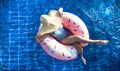 A woman in a hat relaxes on an inflatable circle in the pool Royalty Free Stock Photo