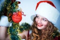 Woman in and hat of Santa with a christmas ball Royalty Free Stock Photo