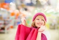 Woman in hat and scarf shopping at supermarket Royalty Free Stock Photo