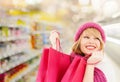 Woman in hat and scarf shopping at supermarket Royalty Free Stock Photo