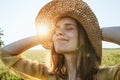 Woman with hat smiling and enjoying summer sunlght in meadow Royalty Free Stock Photo