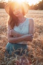 Woman with hat in summer field golden wheat, freedom concept. Happy girl enjoying life, colorful field with ripe Royalty Free Stock Photo