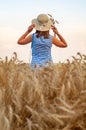 Woman with hat in summer field golden wheat, freedom concept. Happy girl enjoying life, colorful field with ripe Royalty Free Stock Photo