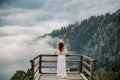 The woman with hat and white dress standing against mountains in nature Royalty Free Stock Photo