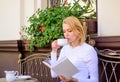 Woman have drink cafe terrace outdoors. Bookworm leisure concept. Mug of good coffee and pleasant book best combination Royalty Free Stock Photo