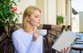 Woman have drink cafe terrace outdoors. Find opportunity to read more. Girl drink coffee while read bestseller book by Royalty Free Stock Photo