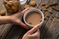 Woman having almond biscuits and a cup of tea with spices Royalty Free Stock Photo