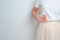 Woman having back abdomen pain with Orange ribbon. Kidney Cancer Awareness March month, disease of Urinary system and Stones,