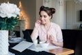 Woman having Breakfast with cereals and milk and looks at tablet Royalty Free Stock Photo