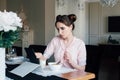 Woman having Breakfast with cereals and milk and looks at tablet Royalty Free Stock Photo