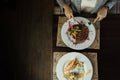 Woman is having breakfast in a restaurant at the table. Time to have lunch. View from above. Healthy food Royalty Free Stock Photo