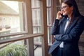 Business conversation on cell phone by window Royalty Free Stock Photo