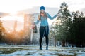 Woman having a city walk in thawing snow