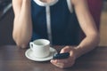 Woman having coffee and using smartphone Royalty Free Stock Photo