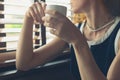 Woman having coffee by the window in a diner Royalty Free Stock Photo