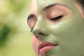 Woman having cosmetic facial seaweed treatment in spa