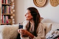 woman having a cup of tea at home during breakfast. Cute golden retriever dog besides. Healthy breakfast with fruits and sweets. Royalty Free Stock Photo