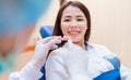 Woman having dental teeth examined dentist check-up with implant false tooth in Clinic