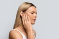 Woman having ear pain, touching her painful head, copy space Royalty Free Stock Photo