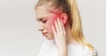 Woman having ear pain, touching her painful head Royalty Free Stock Photo