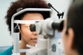 Woman having eyes measured with refractometer Royalty Free Stock Photo