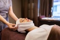 Woman having face massage with towel at spa parlor Royalty Free Stock Photo