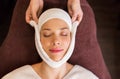 Woman having face massage with towel at spa Royalty Free Stock Photo