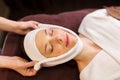 Woman having face massage with towel at spa Royalty Free Stock Photo