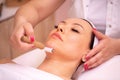 Woman having a facial madero therapy with face roller Royalty Free Stock Photo