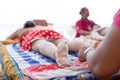 Woman having foot scrub on the beach Royalty Free Stock Photo