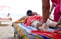 Woman having foot scrub and massage on the beach Royalty Free Stock Photo