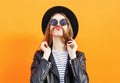 Woman having fun shows moustache hair over orange