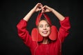 Woman holding thread with four heart shapes