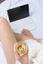 Woman having a glass of wine in bed Royalty Free Stock Photo