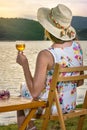 Woman having glass of wine by the lake Royalty Free Stock Photo