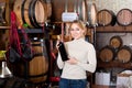 Woman having glass of wine in wine house