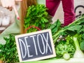 Woman having green diet vegetables, detox sign