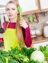 Woman having green vegetables thinking about cooking Royalty Free Stock Photo