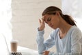 Woman having headache migraine at desktop in office Royalty Free Stock Photo