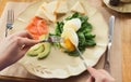 Woman having healthy breakfast with poached eggs and smoked salm Royalty Free Stock Photo