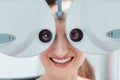 Woman having her eyesight measured with phoropter Royalty Free Stock Photo