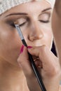 Woman having her makeup applied