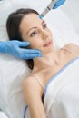 Woman having hydrafacial skincare procedure in beauty clinic