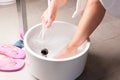 Woman having hydrotherapy water footbath