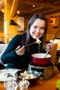 Woman having meal in Swiss restaurant, eating fondue Royalty Free Stock Photo