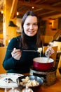 Woman having meal in Swiss restaurant, eating fondue Royalty Free Stock Photo